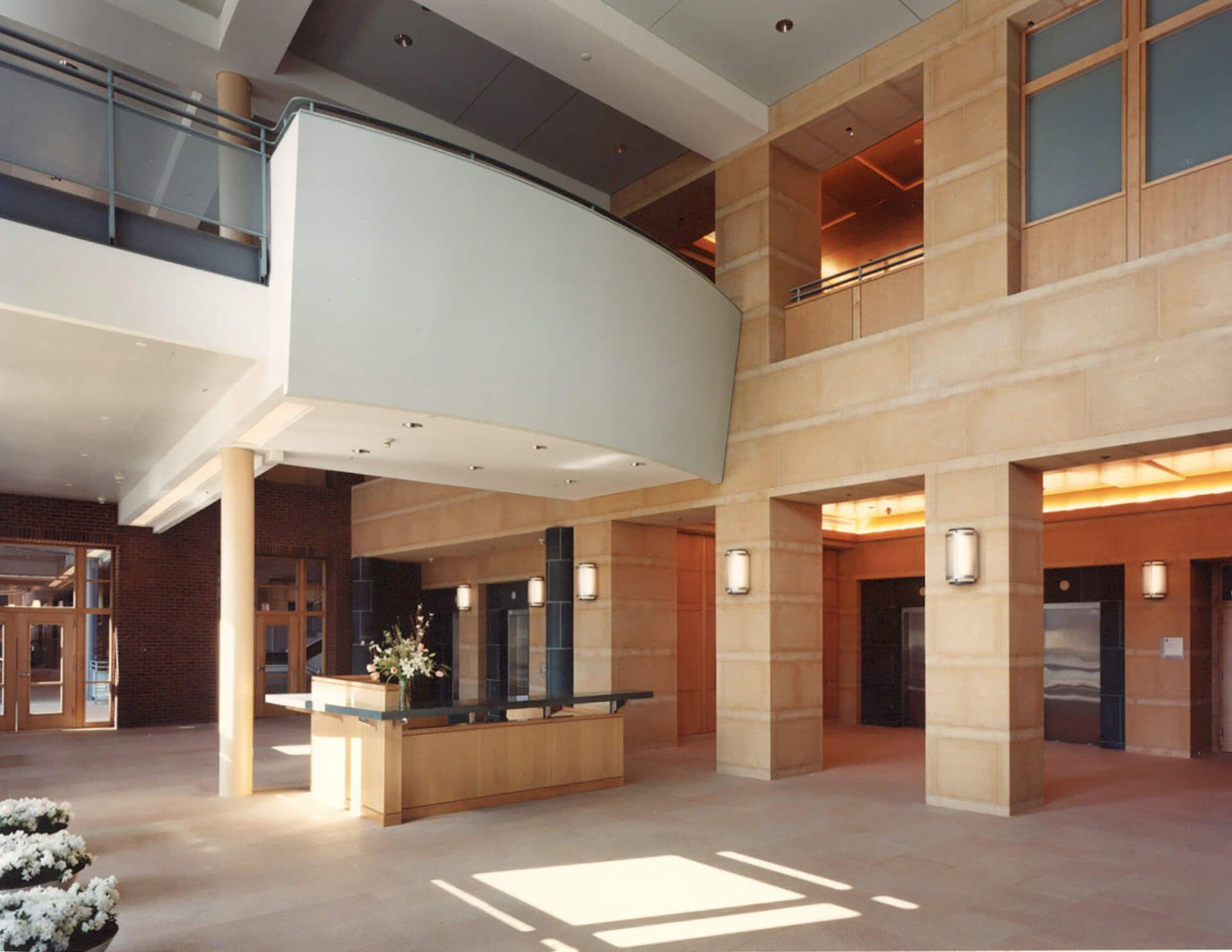 a large lobby with a reception desk in the middle