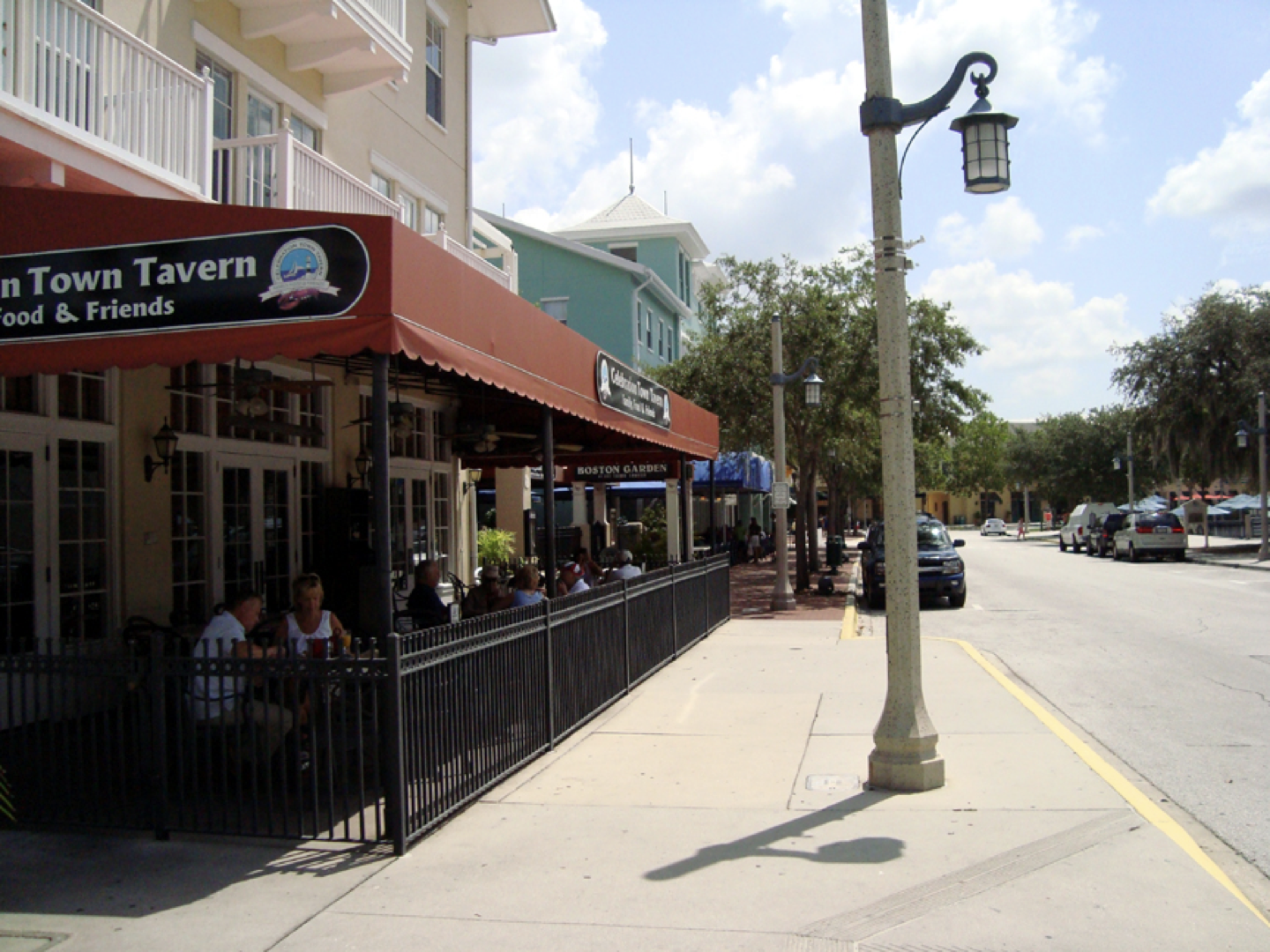 a restaurant with a red awning that says tom towit tavern