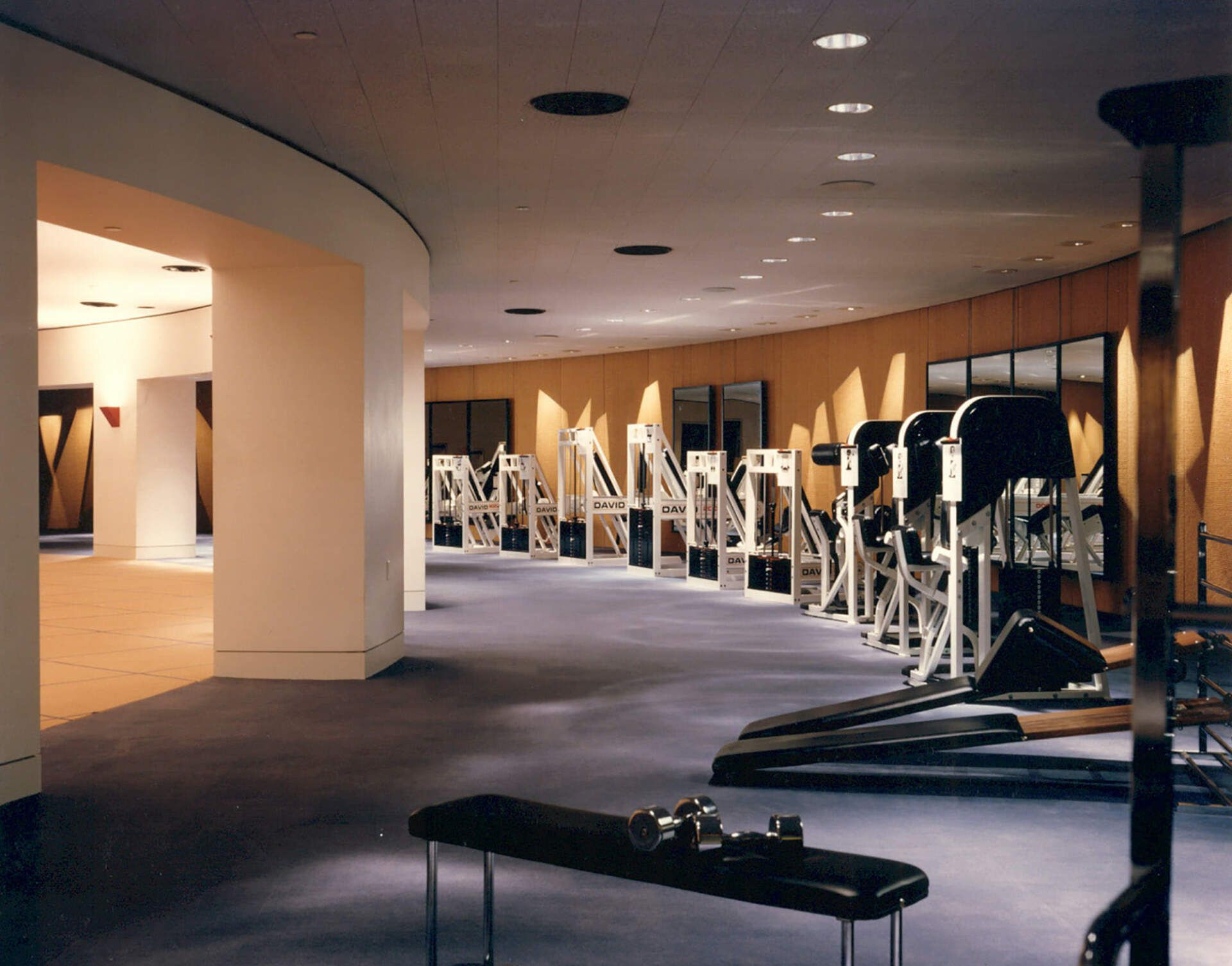 a gym with a bench in the middle of it