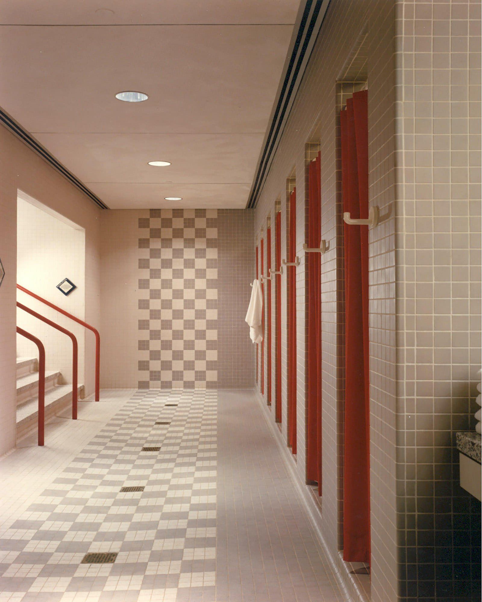 a hallway with a checkered floor and a staircase