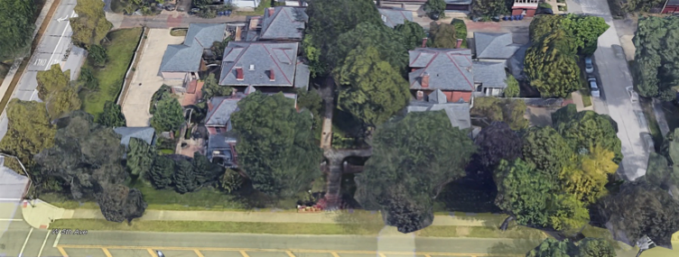 an aerial view of a residential area with lots of trees and houses