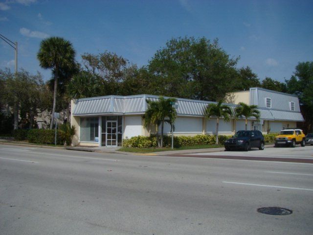 a yellow jeep is parked in front of a building