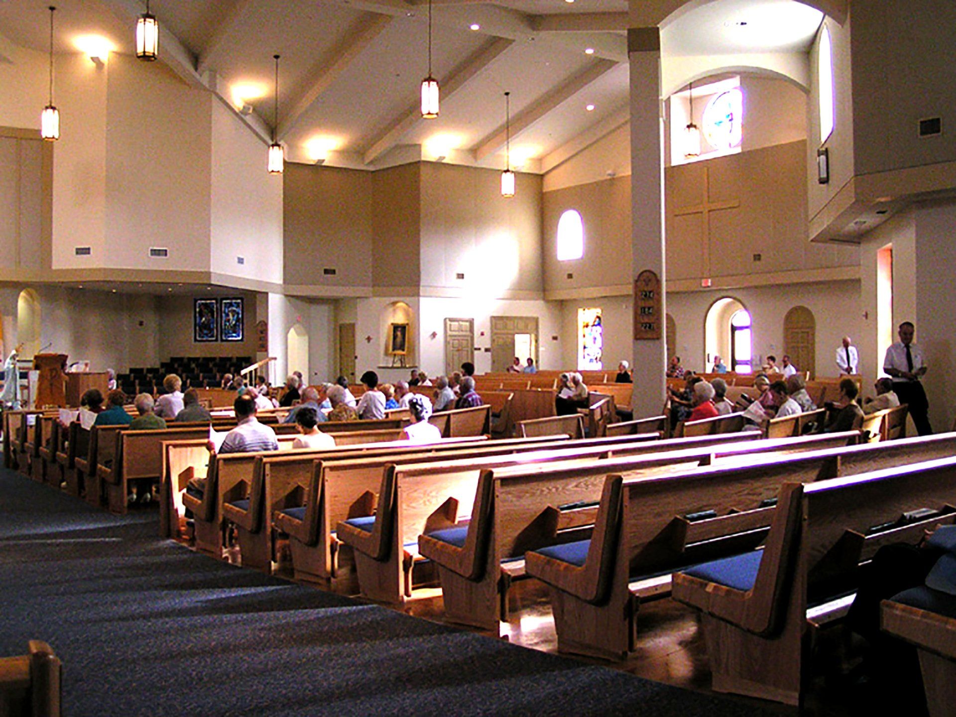 a church with a lot of people sitting in the pews
