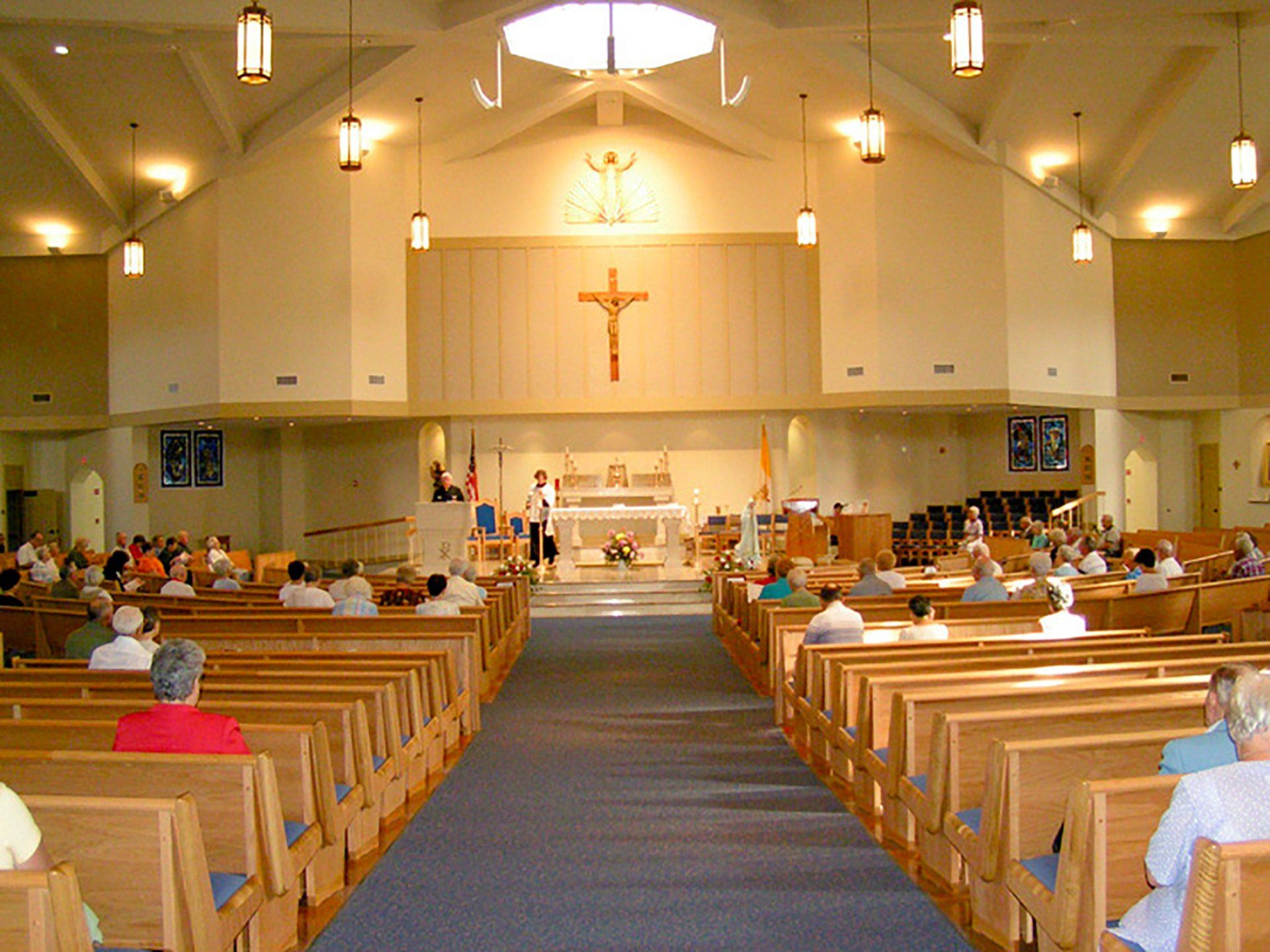 the inside of a church with a cross on the wall