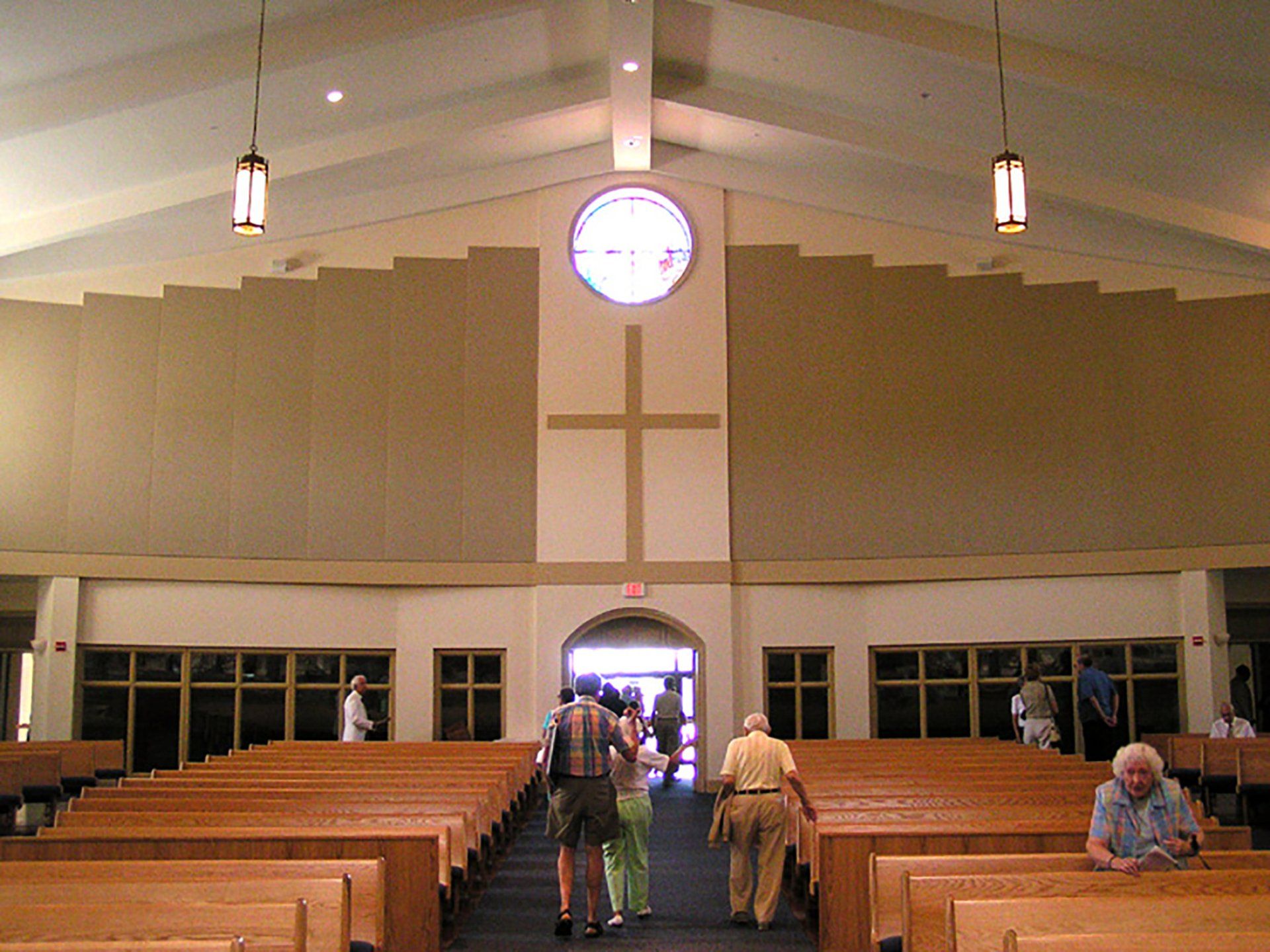 the inside of a church with a cross on the wall