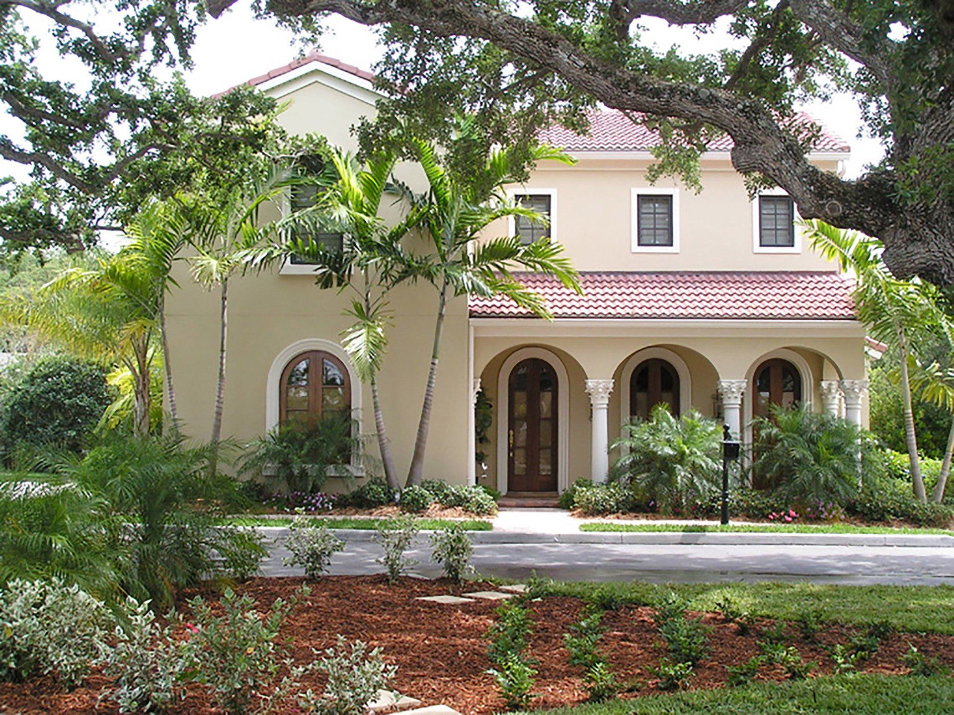 a large house with arched windows and a red tile roof