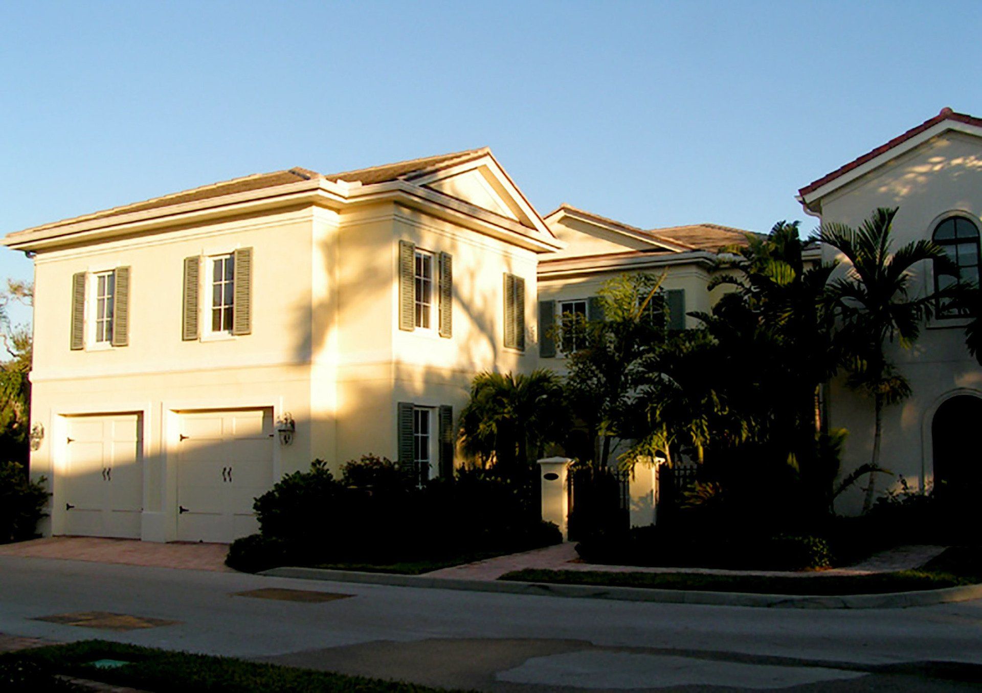a large white house with shutters on the windows