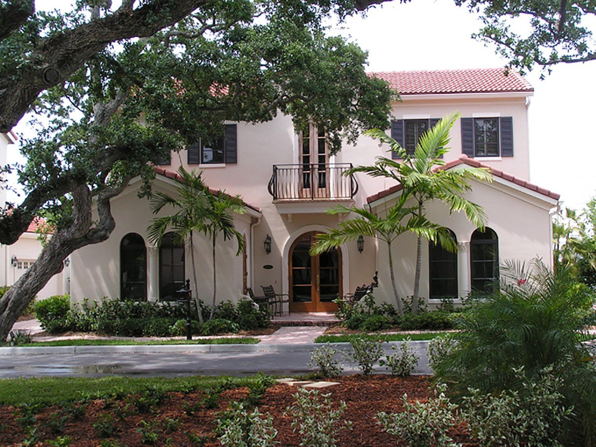 a large white house with a red tile roof