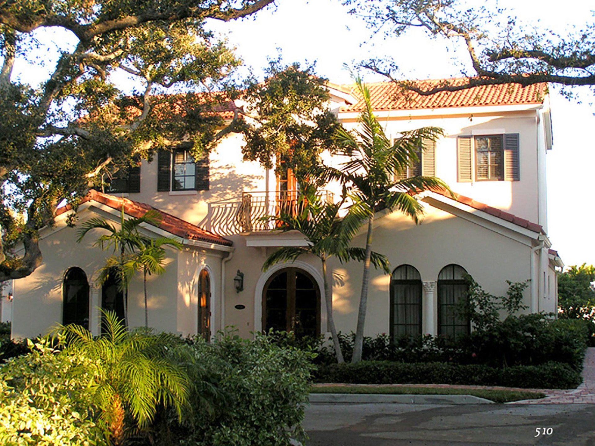 a large white house with a red tile roof