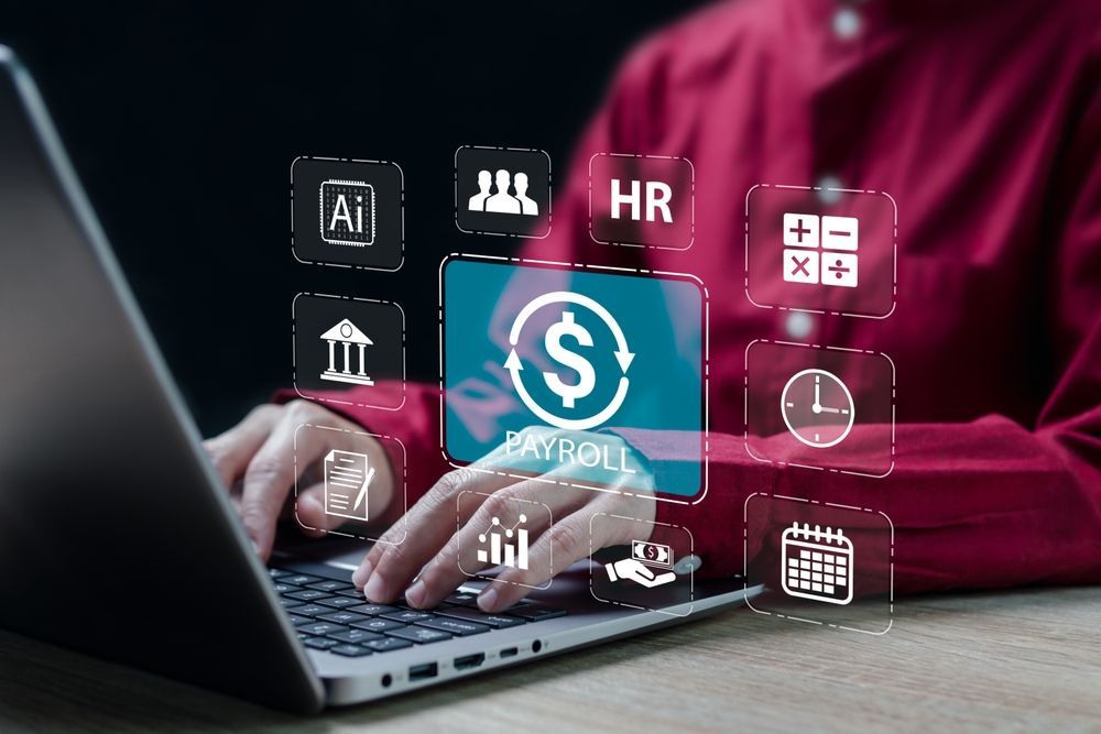 A person is typing on a laptop computer with a dollar sign on the screen.