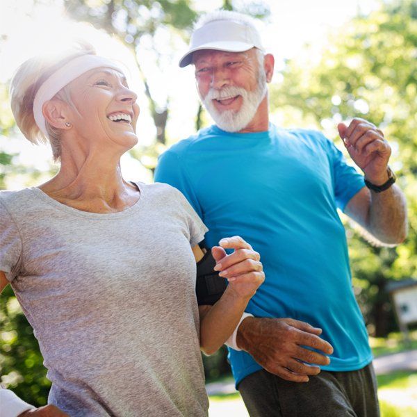 Senior Couple Jogging At Park — Wilmington, DE — S.M.A.R.T Tax Free Retirement