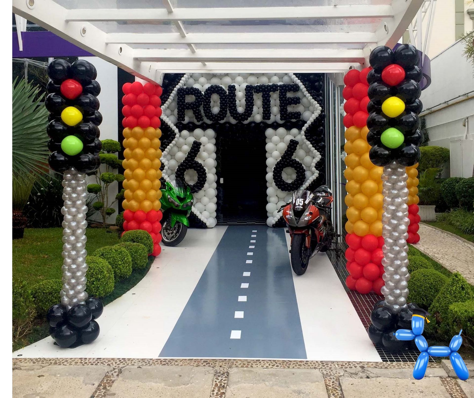 Route 66 themed balloon decoration complete with as balloon wall stating route 66 and 2 stoplight balloon columns