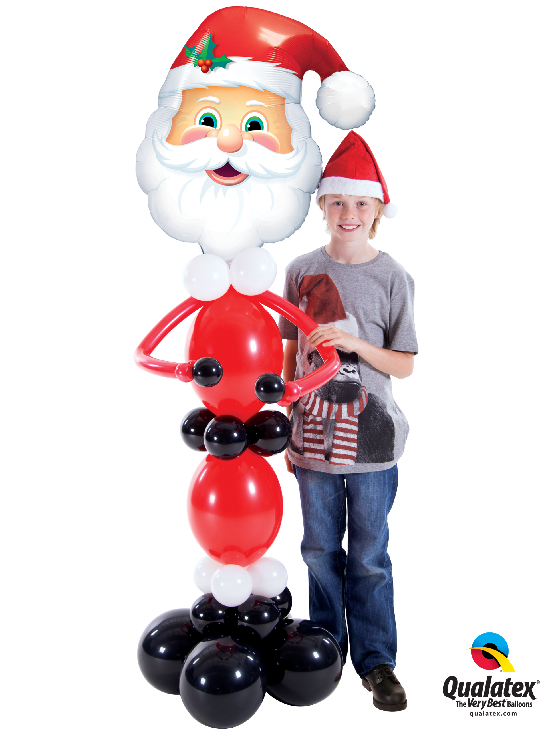 A boy is standing next to a santa claus balloon