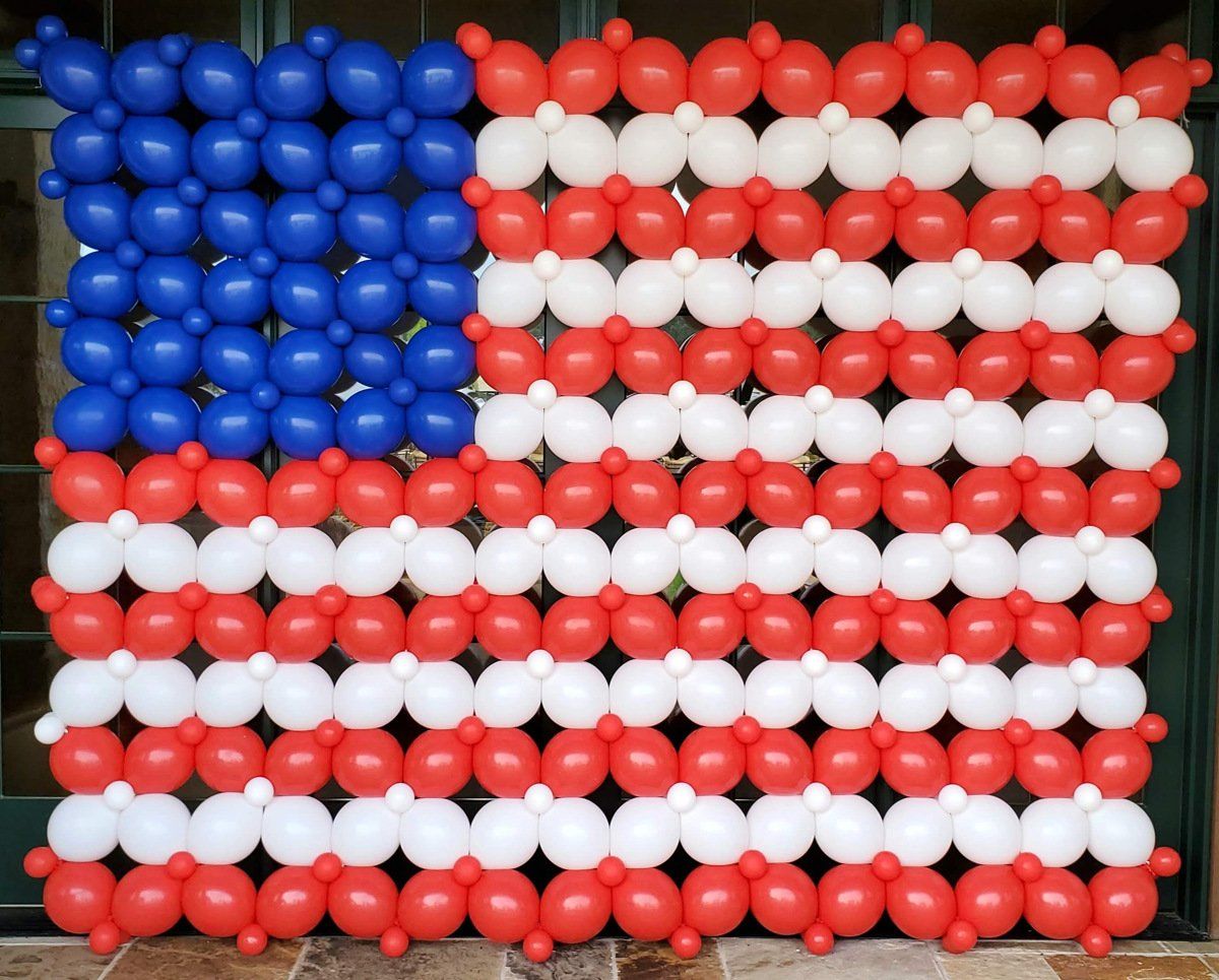 An american flag made of red white and blue balloons