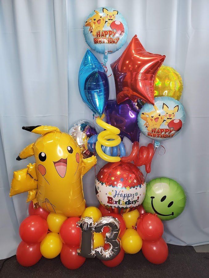 A bunch of balloons with pikachu and the number 13 on them