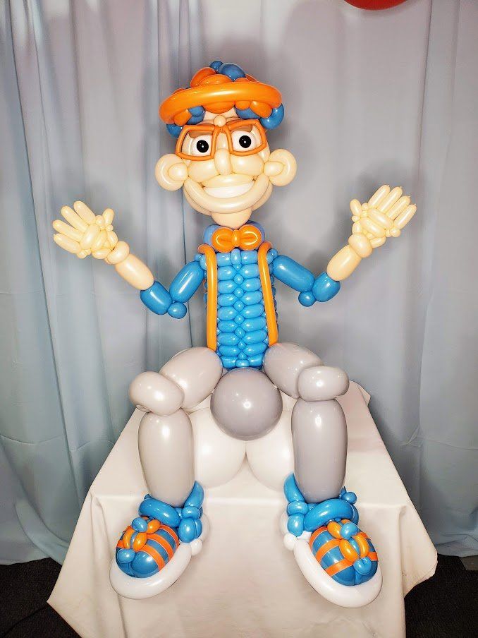 A balloon figure of a boy with glasses and a bow tie