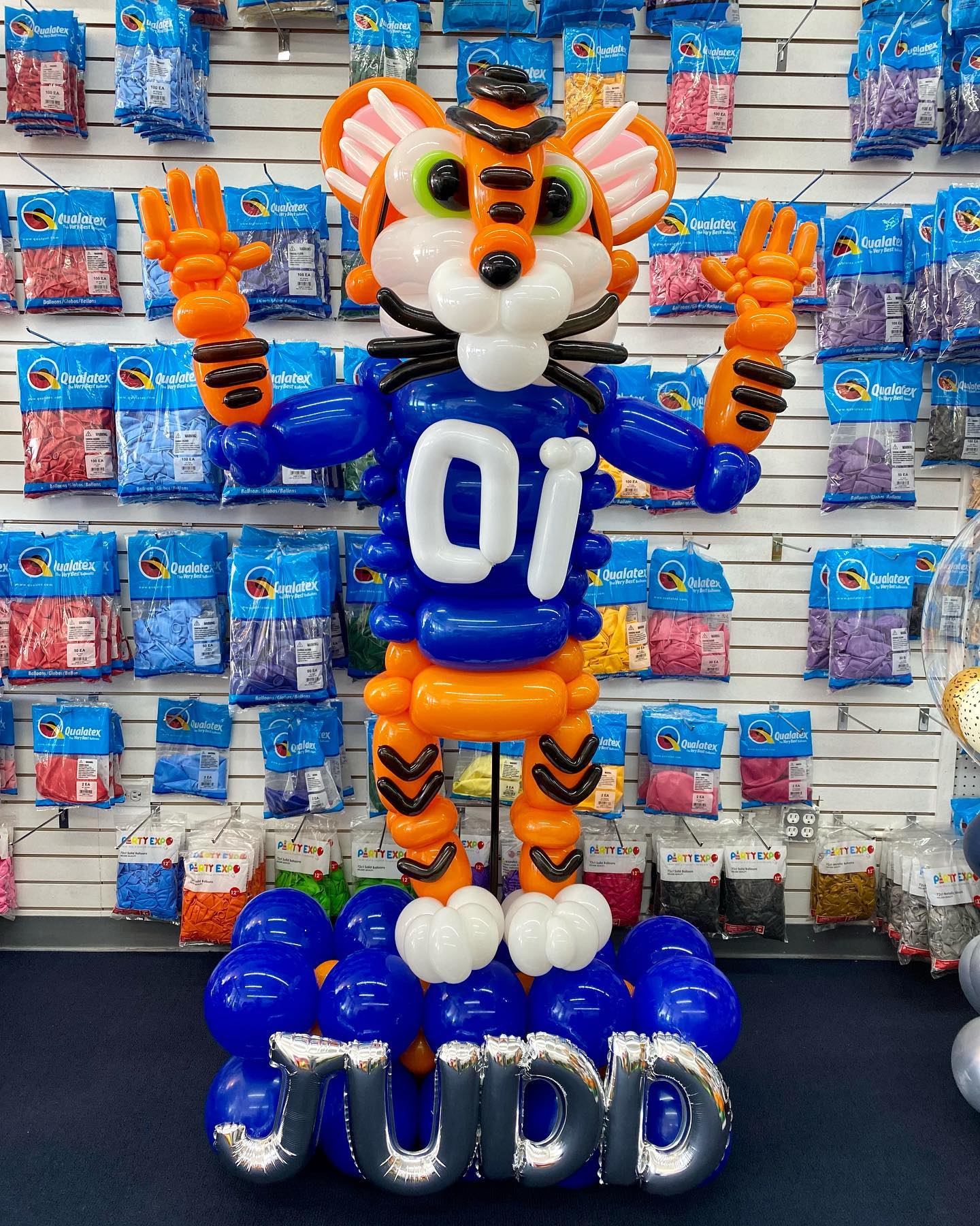 A tiger made out of balloons with the name judd on it