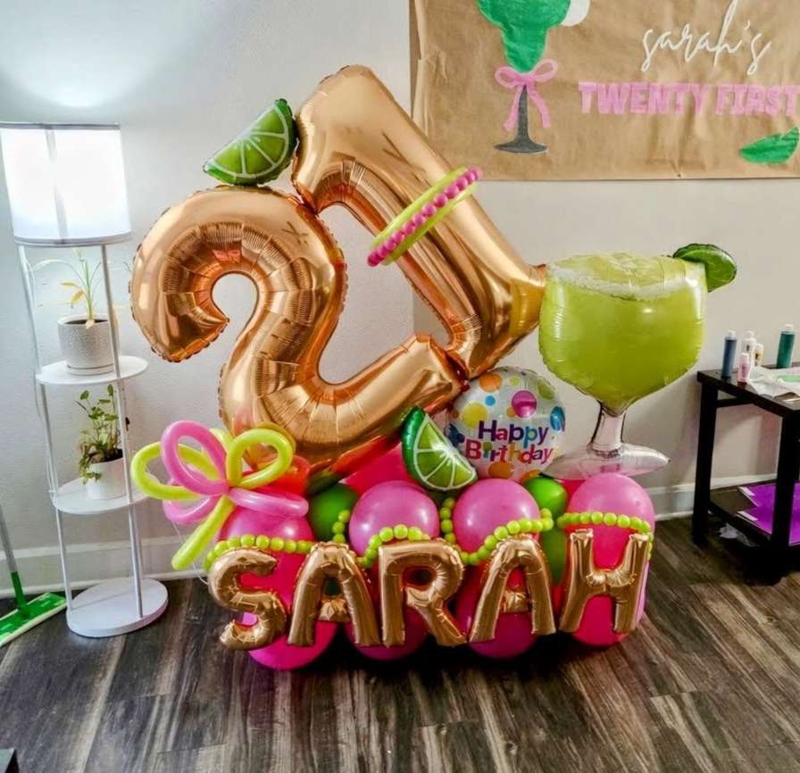 21st birthday balloon centerpiece with rose gold '21' and 'SARAH' foil balloons, margarita theme, lime accents, pink and green balloons, custom name garland, perfect for tropical cocktail 21st birthday party decoration
