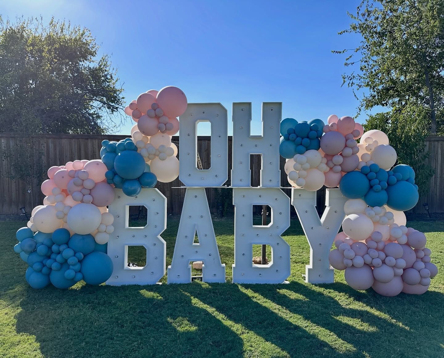 Baby shower backdrop with marquee letters and balloon garland for Fort Worth event decor