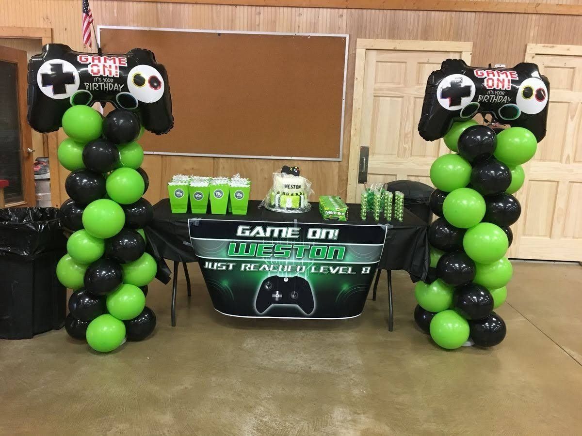 A table with balloons and a sign that says game on