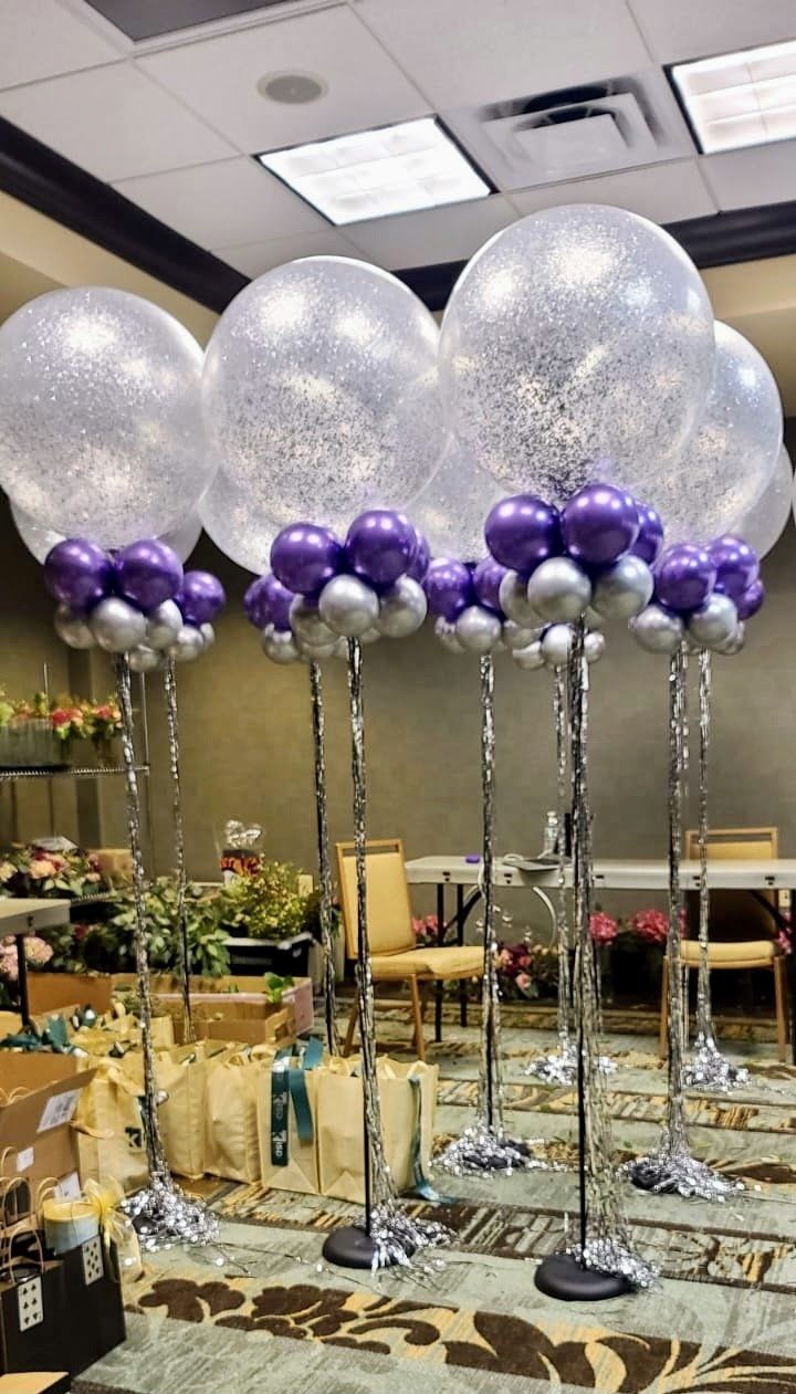 A bunch of balloons are sitting on top of each other in a room.