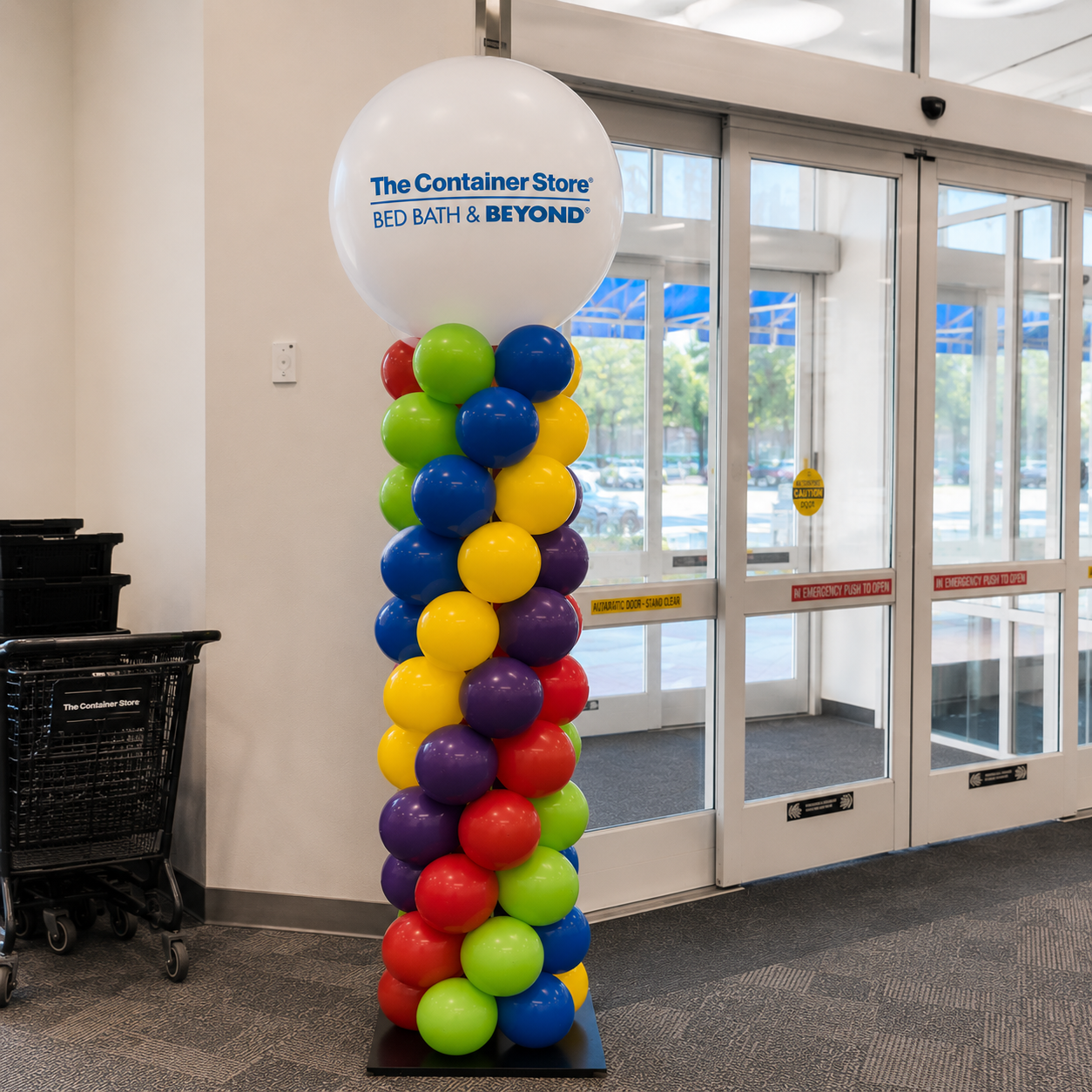 Corporate balloon column decor for the container store in company colors and a company logo.