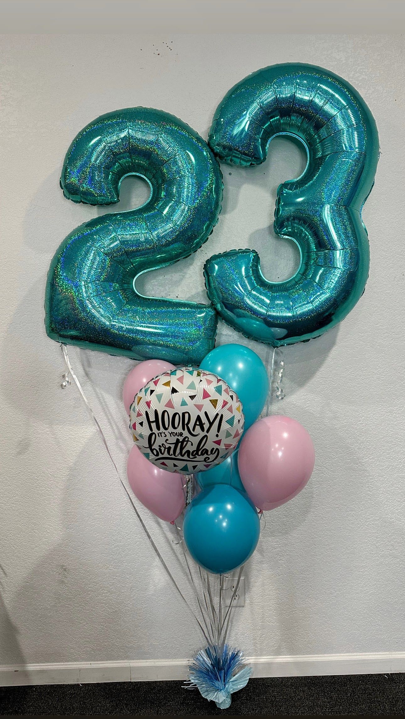 A bunch of balloons with the number 23 on them.