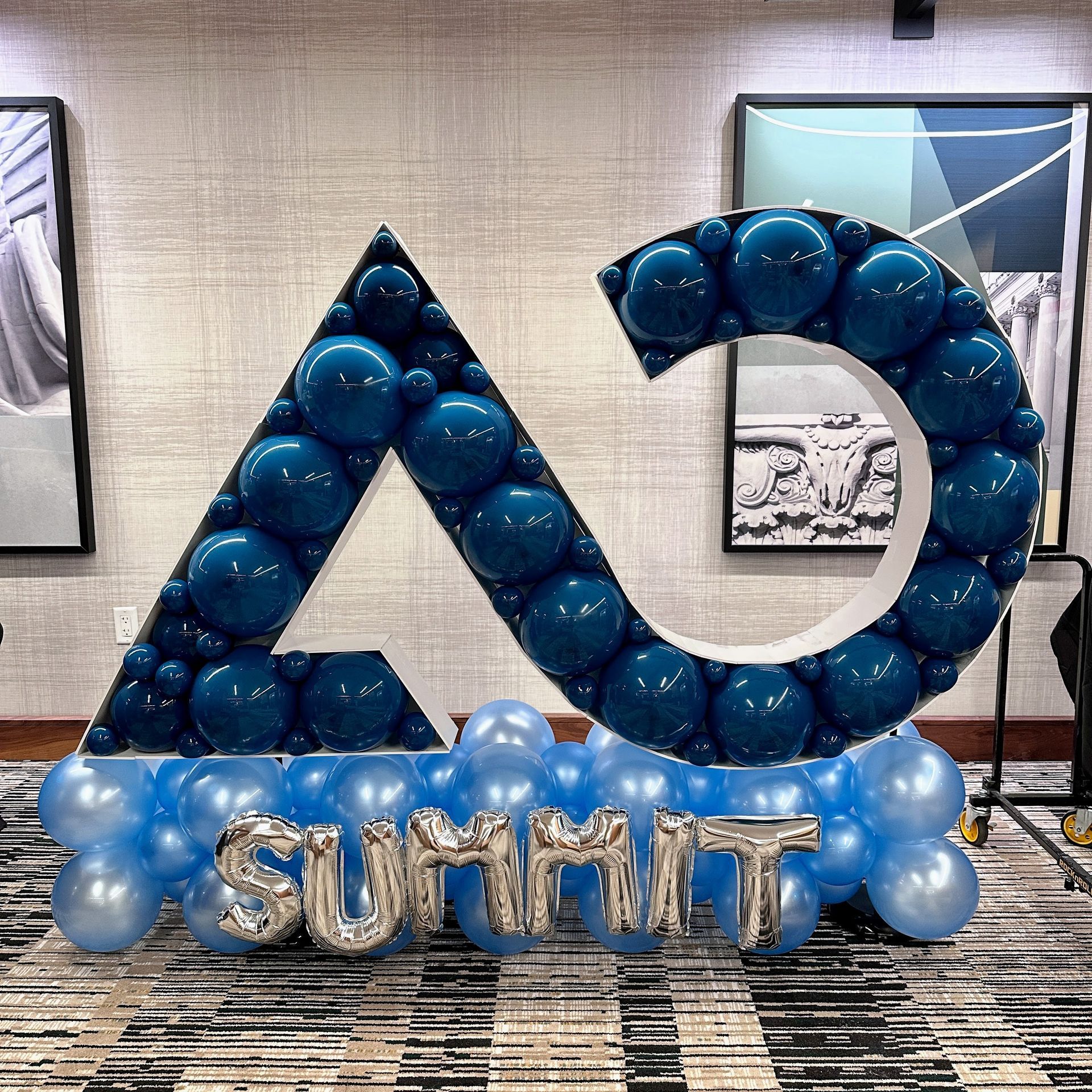 Custom balloon mosaic logo display with letters for branded event decor in Fort Worth Texas