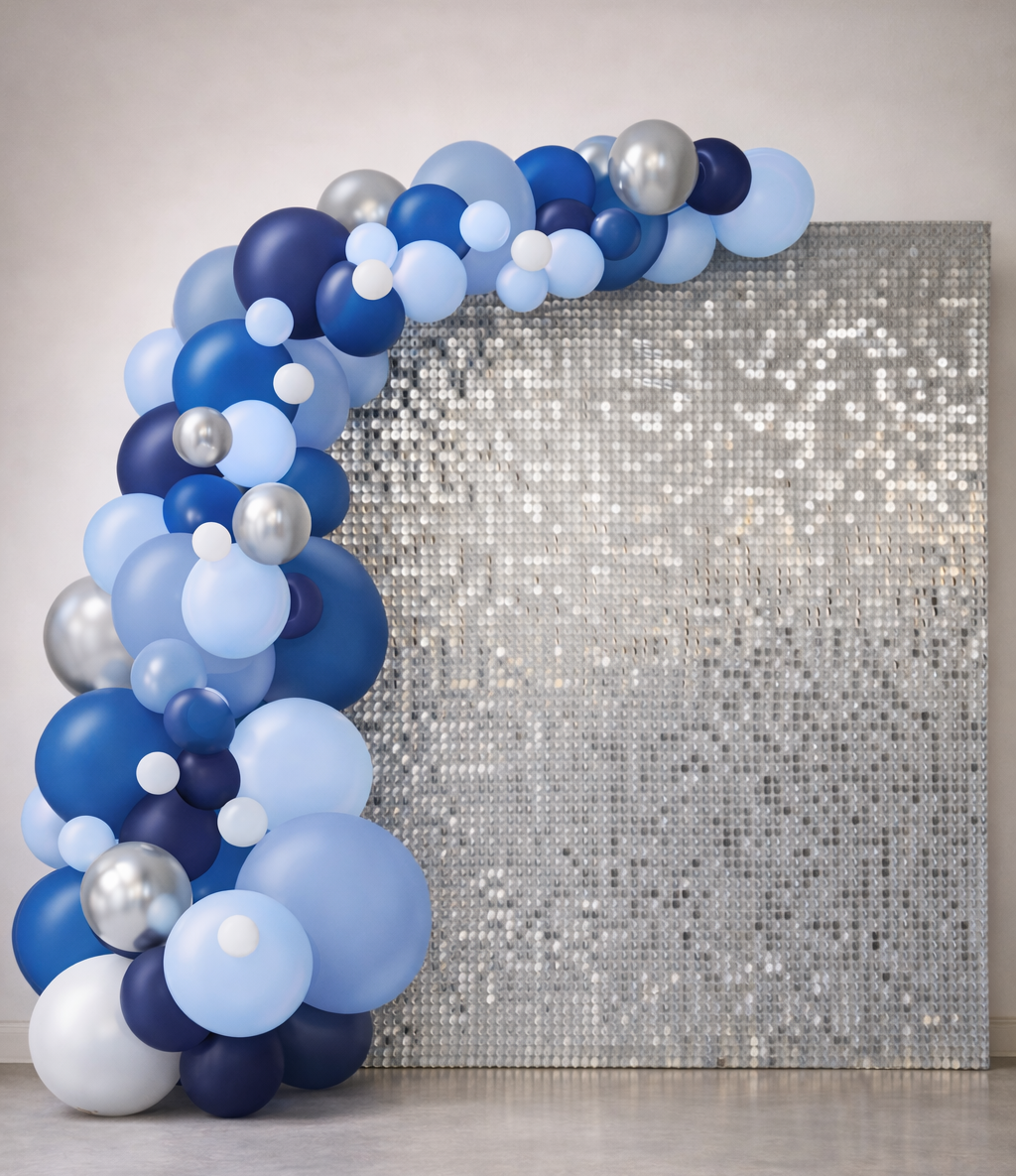 A silhouette of a woman standing in front of a balloon arch