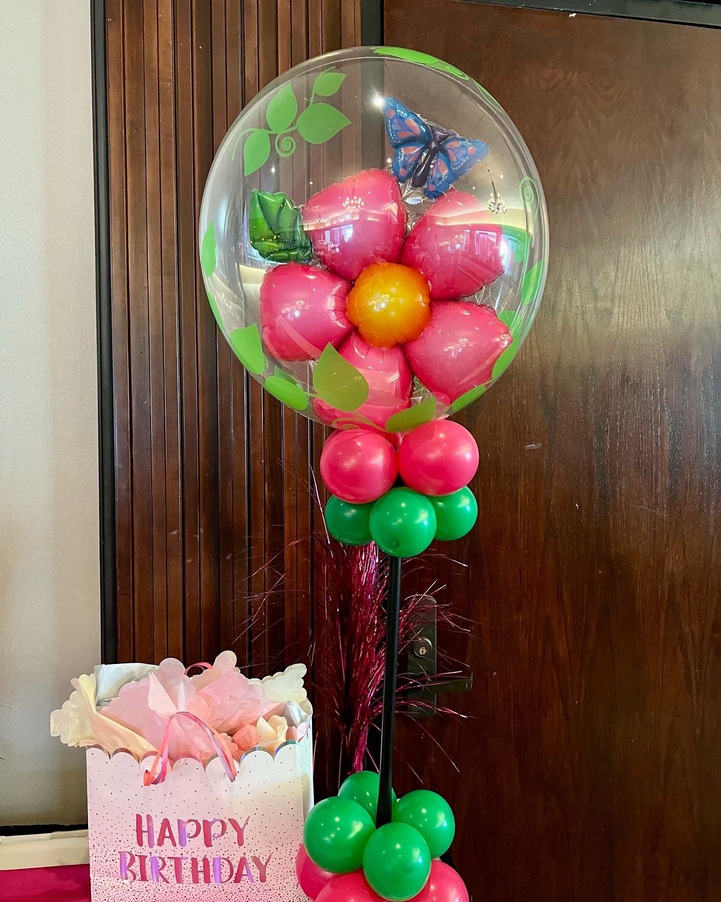 A happy birthday card is next to a balloon