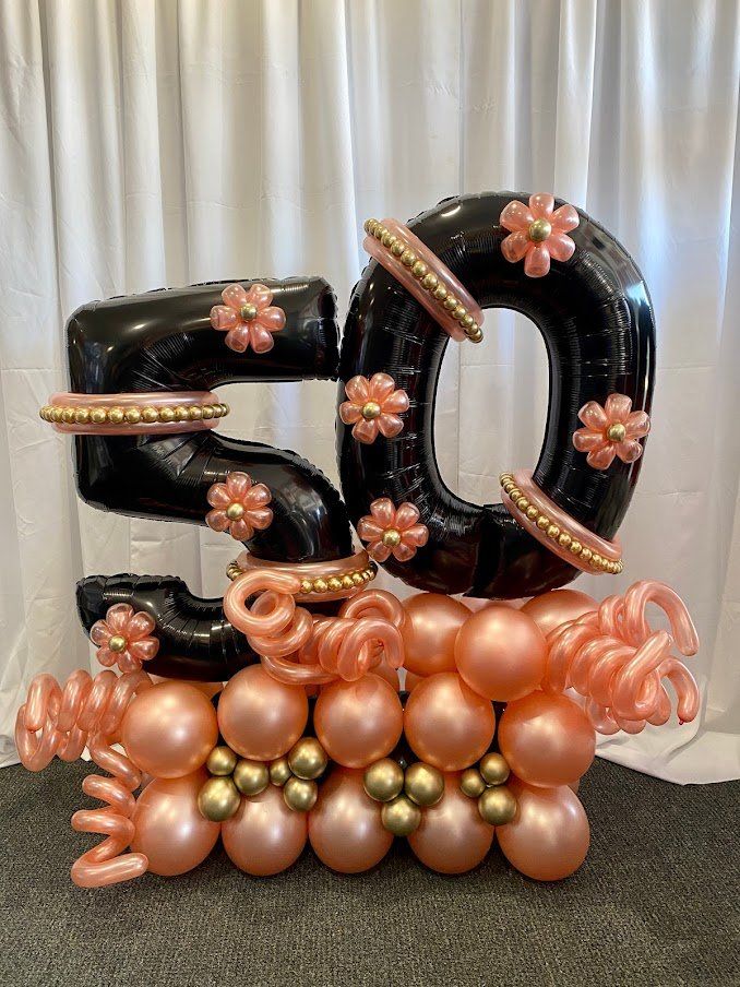 The number 50 is made of balloons and flowers.