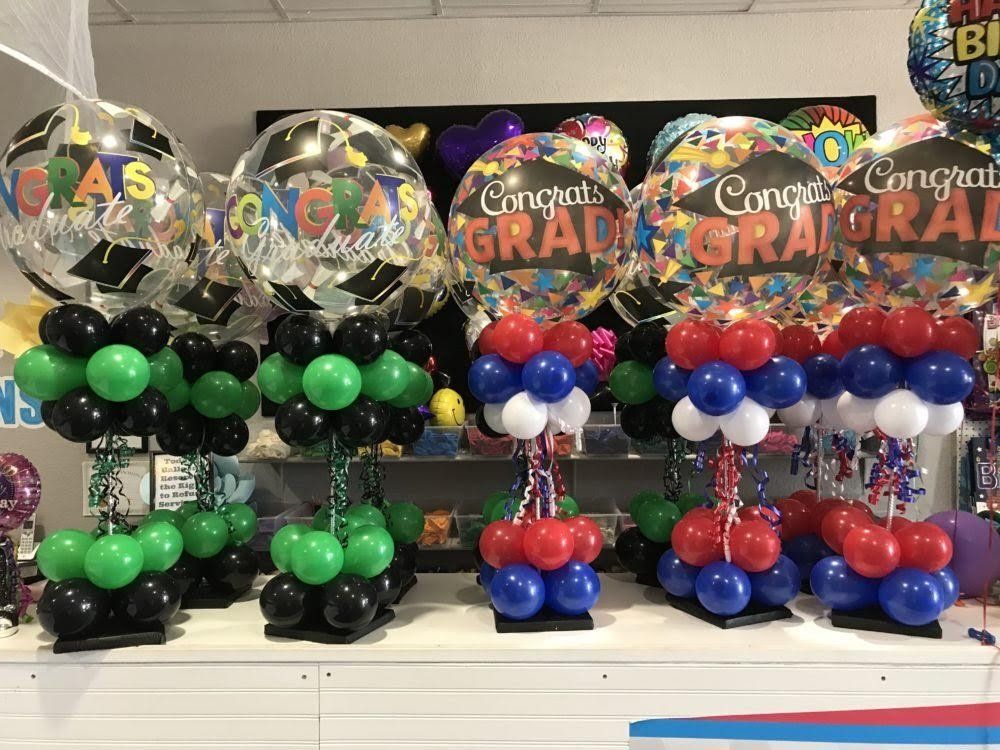 A bunch of balloons are sitting on top of each other on a table.