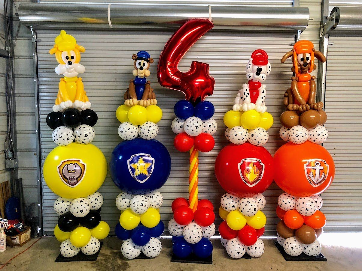 A bunch of balloons are stacked on top of each other in a room.