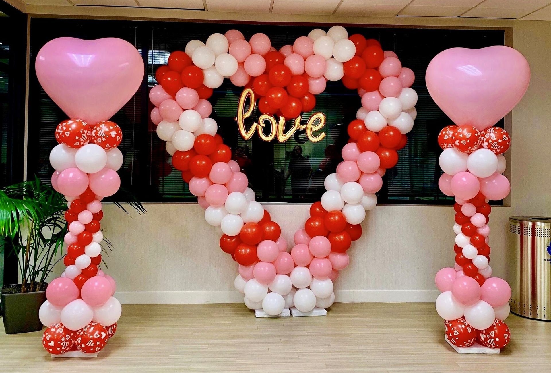 A heart made of balloons with the word love written on it