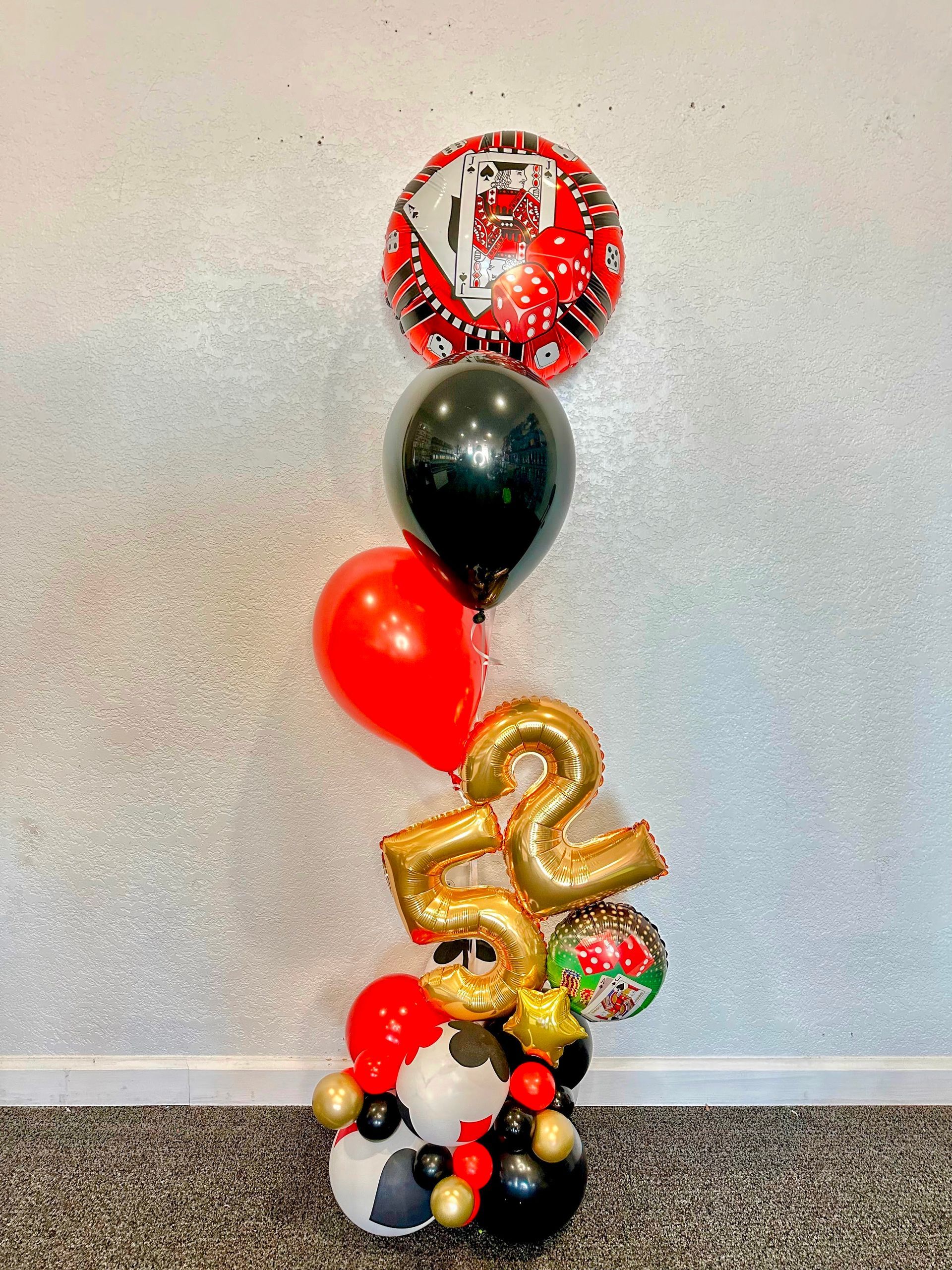 A bunch of balloons are sitting on top of a table.