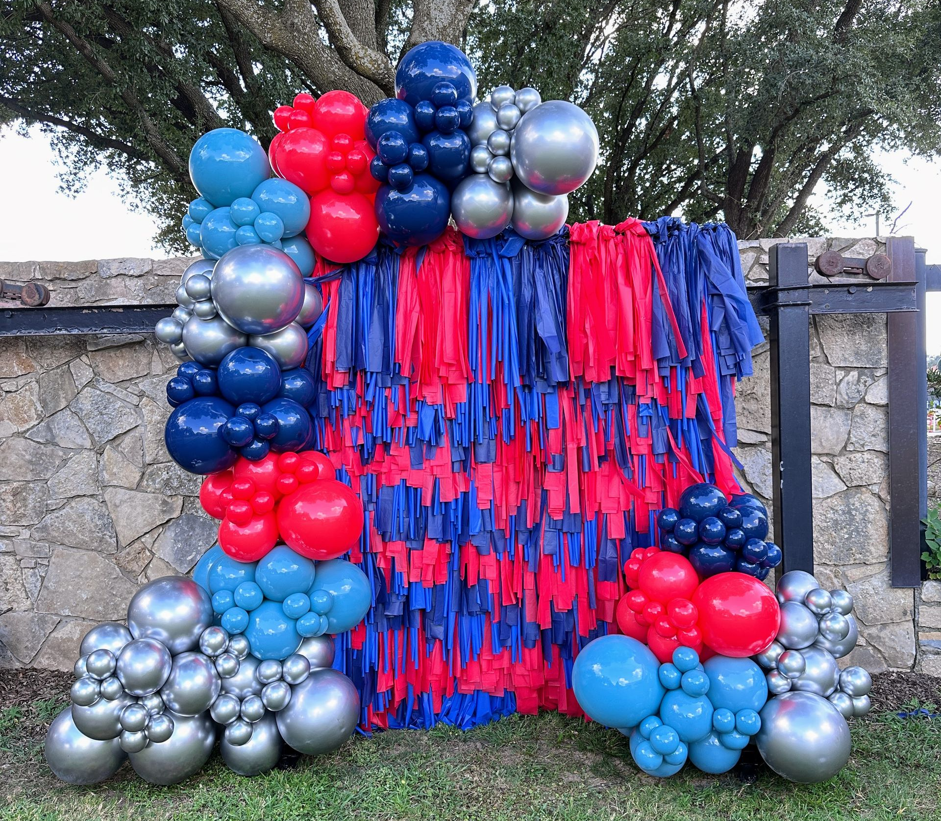 Custom fringe backdrop with balloon garland for event photo wall in Fort Worth Texas