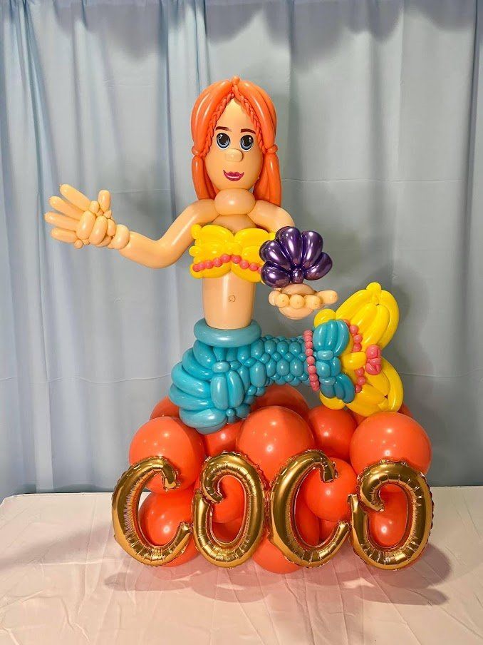 A mermaid made out of balloons with the name coco