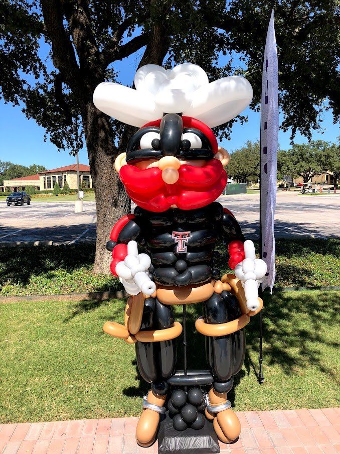 A statue of a cowboy made out of balloons
