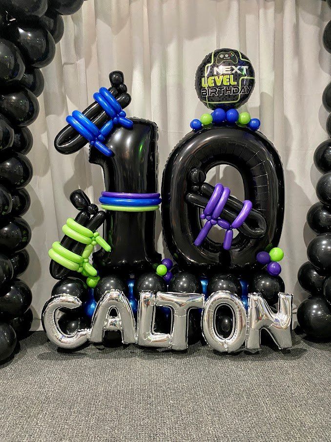The number 10 is made of balloons and the name calton is made of balloons.