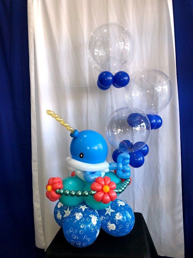 A narwhal made out of balloons is sitting on a table
