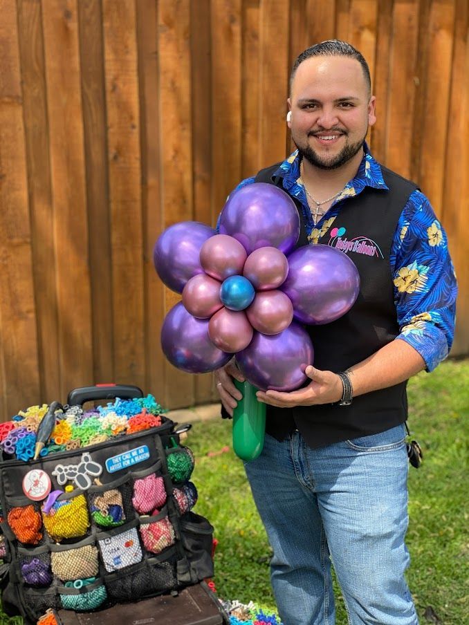 A man is holding a purple balloon in the shape of a flower.
