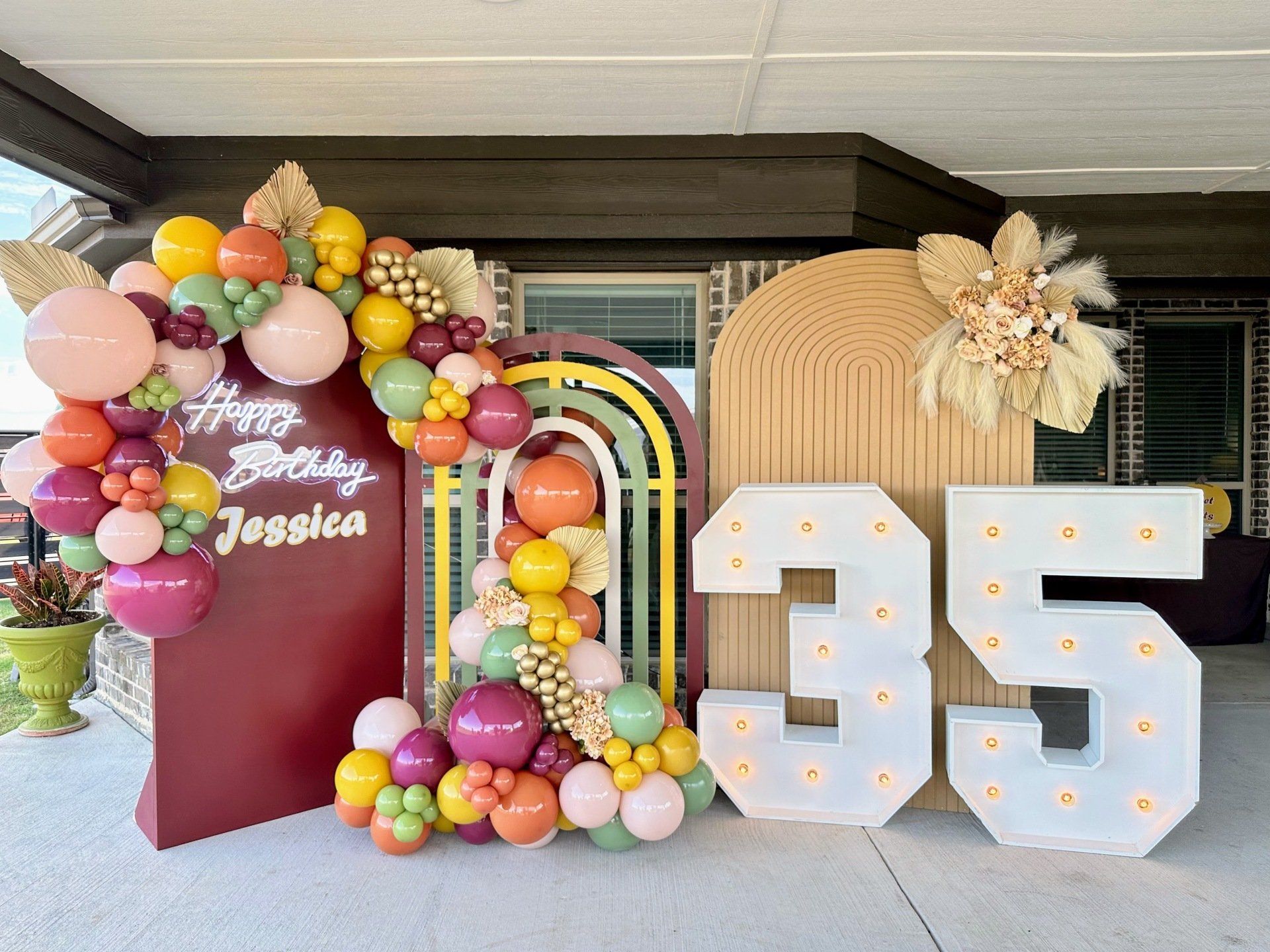 A birthday party with balloons and a sign that says happy birthday jessica.