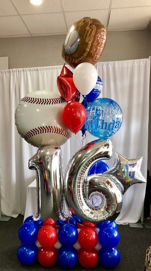 A bunch of balloons are stacked on top of each other in a room.