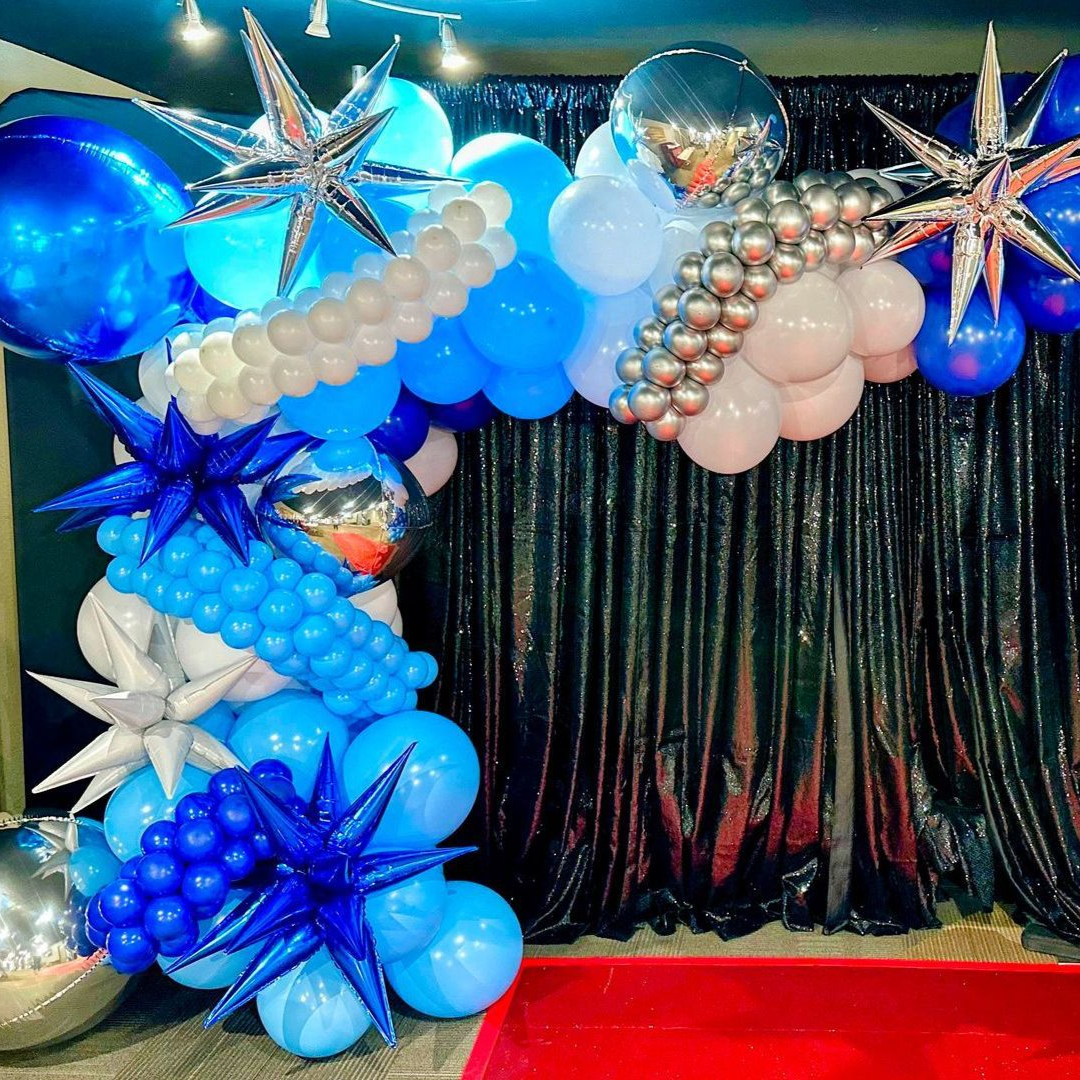 High end corporate balloon installation with blue and silver balloons and star accents for formal event