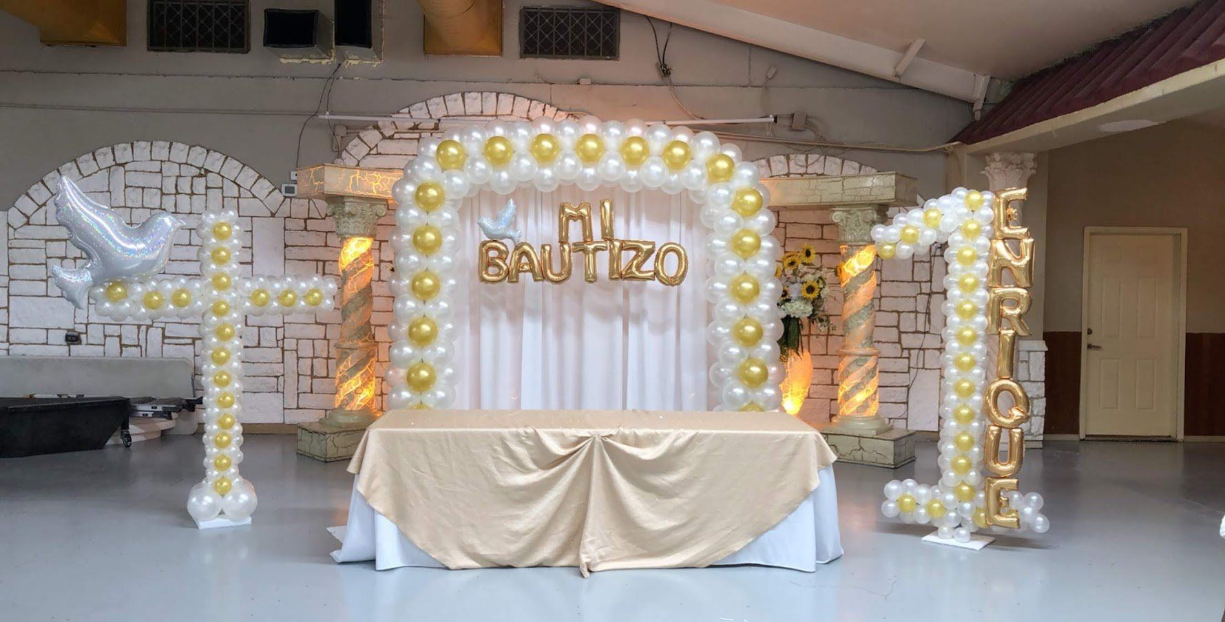 A room decorated with balloons and a table.