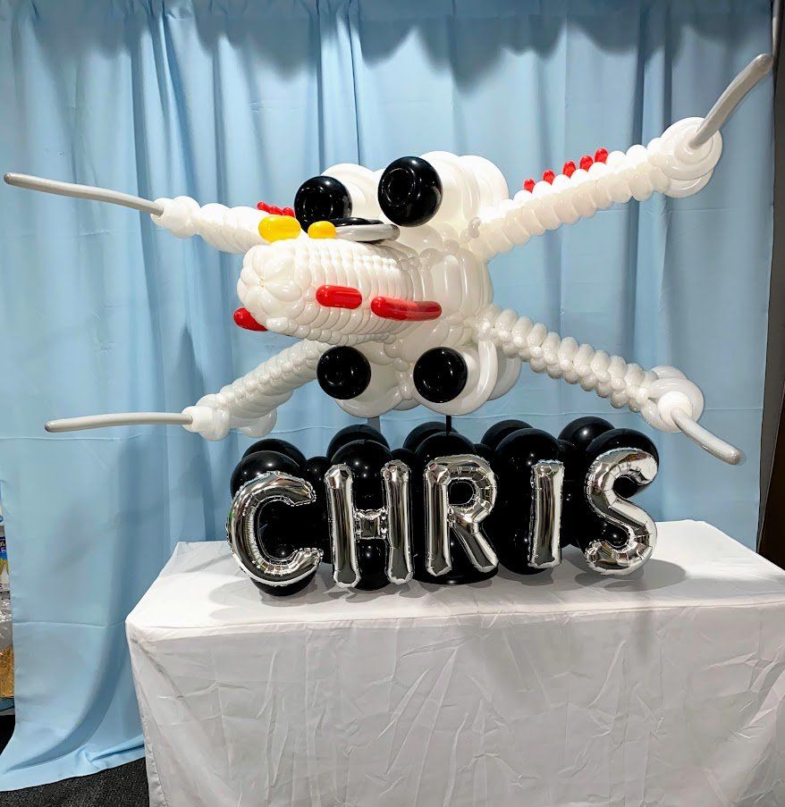 A balloon airplane with the name chris on it