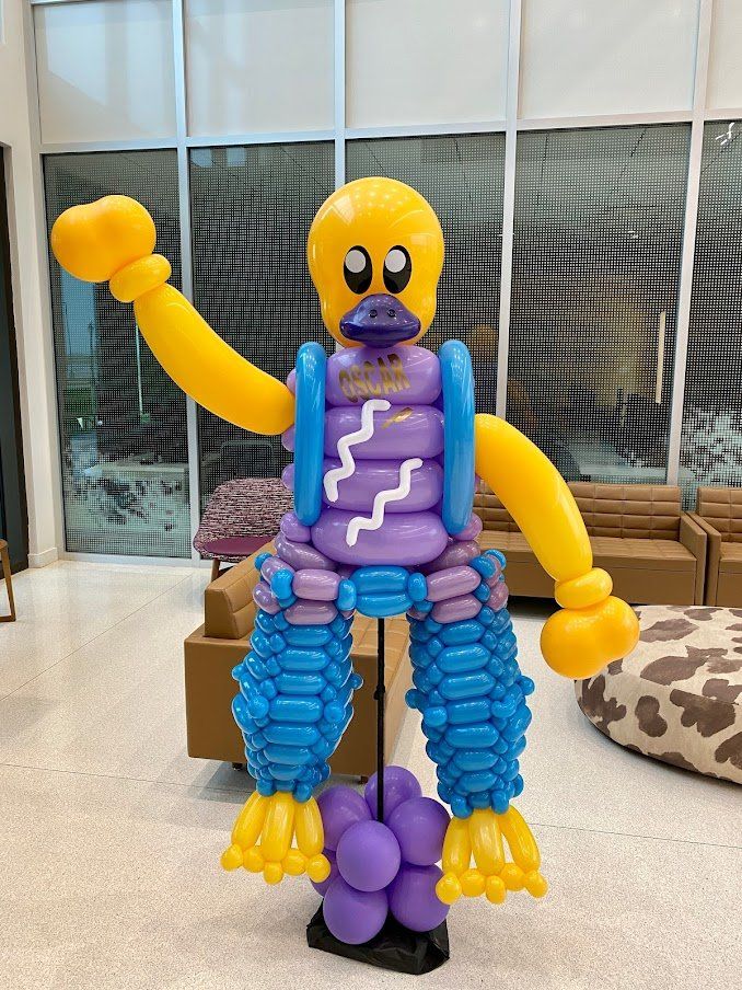 A robot made out of balloons in a living room