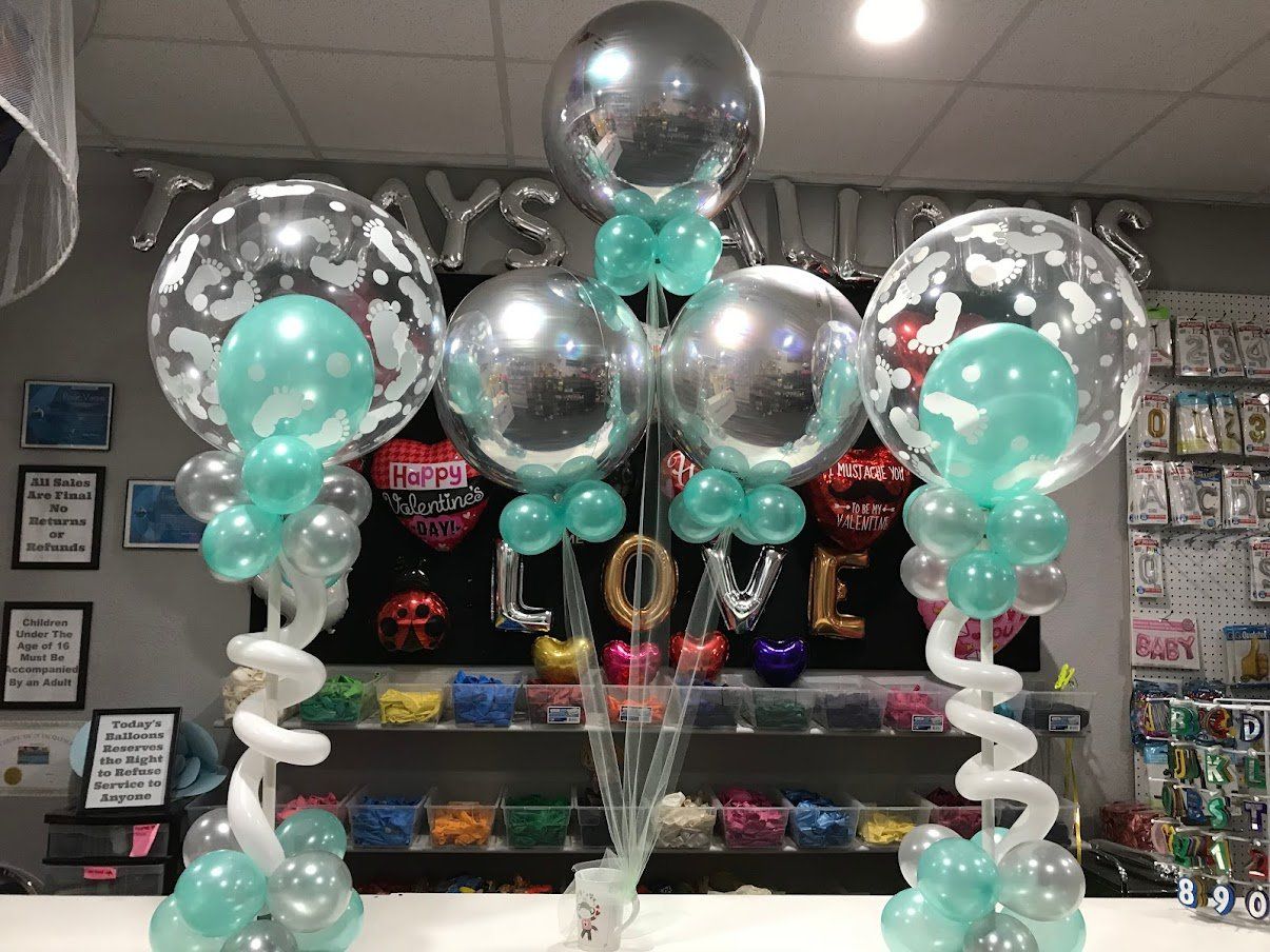 A bunch of balloons are sitting on top of a table.