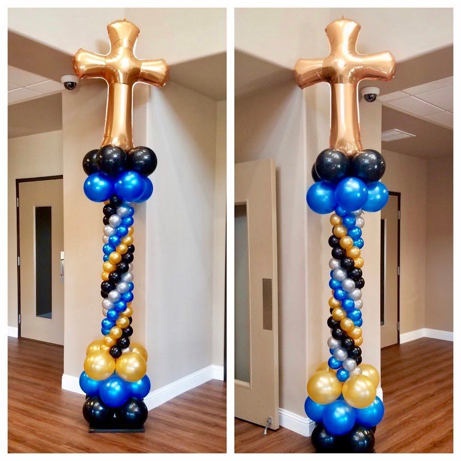 A balloon pillar with a cross on top of it.