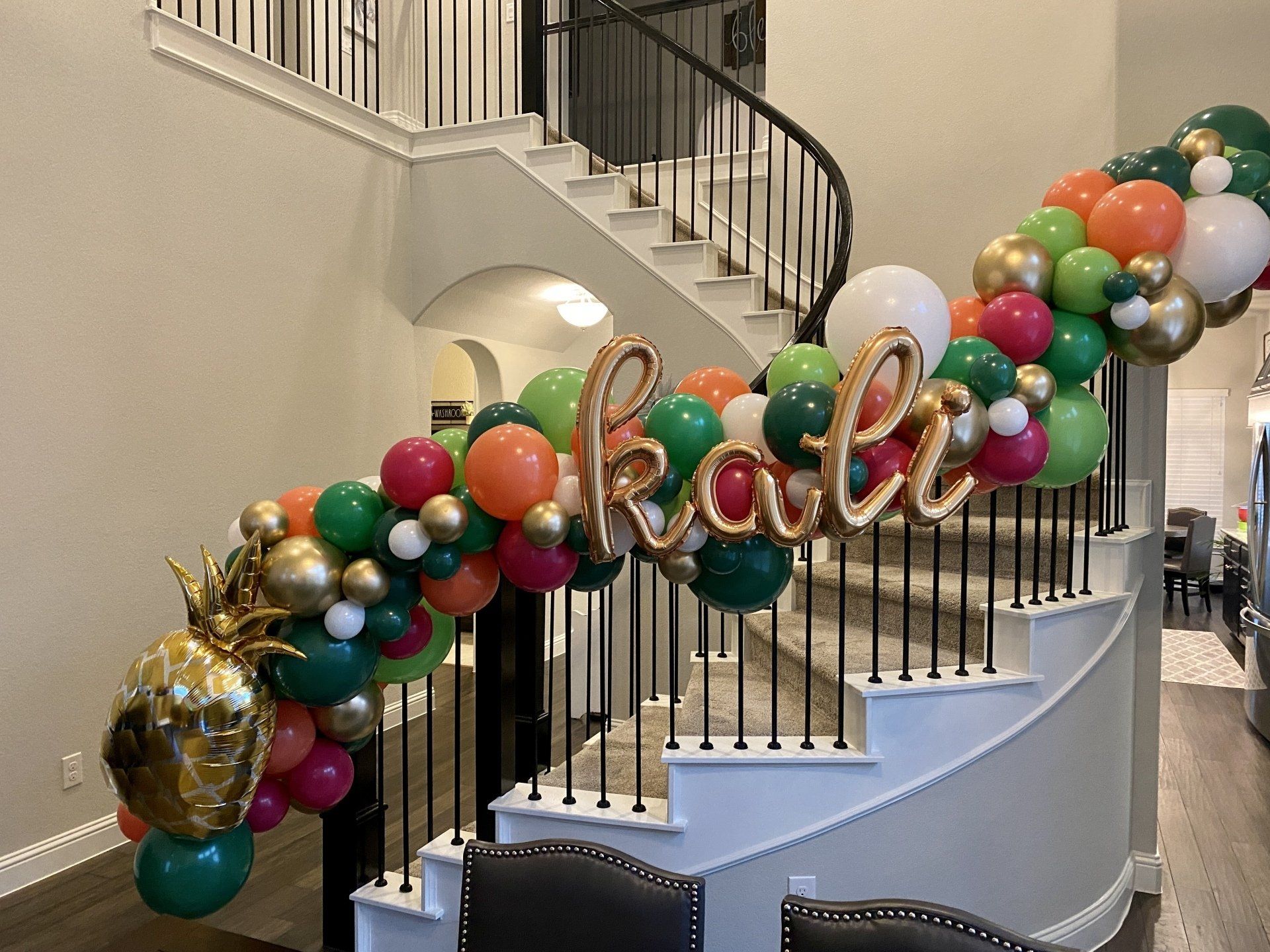 A staircase decorated with balloons and a sign that says `` kali ''.